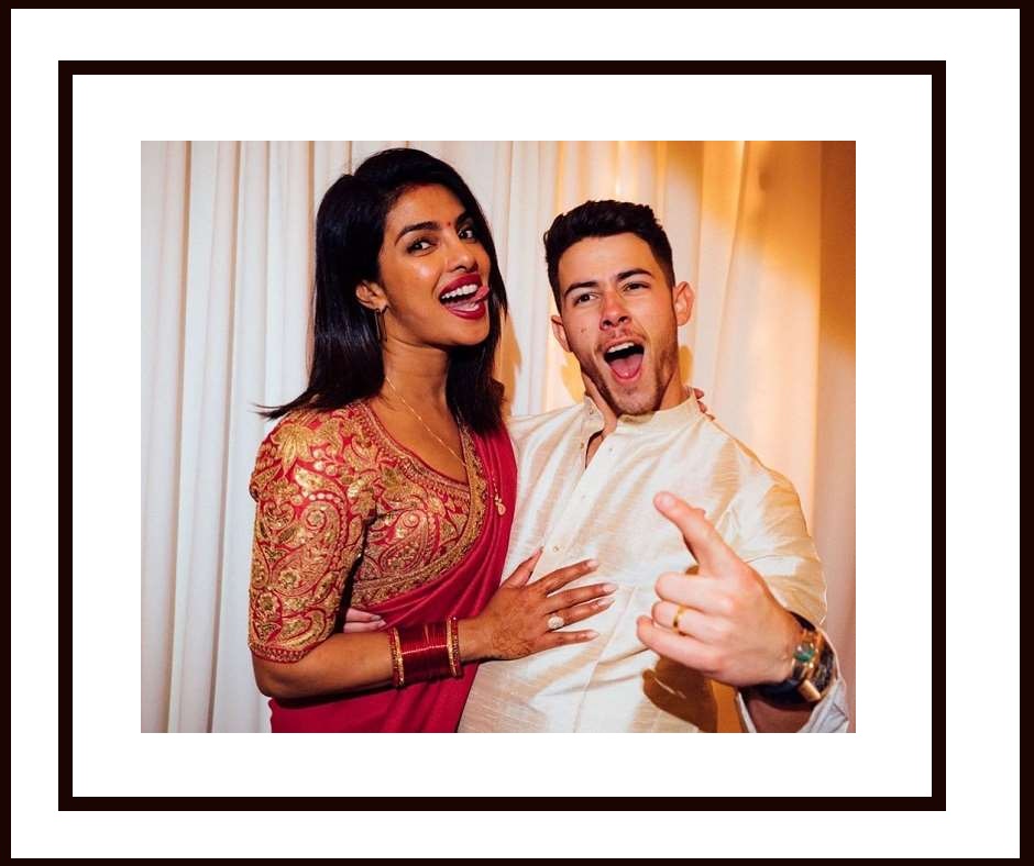 Premium Photo | Beautiful indian woman in a red saree holding karva chauth  accessories