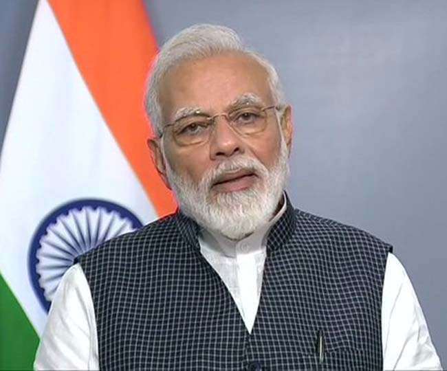 New Delhi, India. 19th July, 2021. Prime Minister Narendra Modi holds an  umbrella to protect from the rain as he addresses the media on the opening  day of the monsoon session of