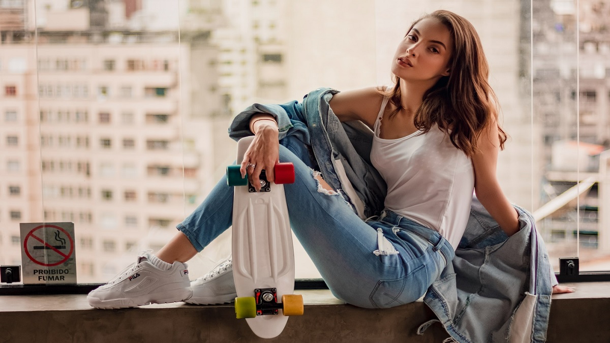 With denim shirt, blue bag and sneakers