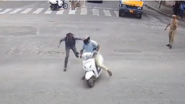 bengaluru-policeman-risks-life-to-stop-notorious-thief-dragged-for-20-meters-dramatic-scene-captured-on-cctv