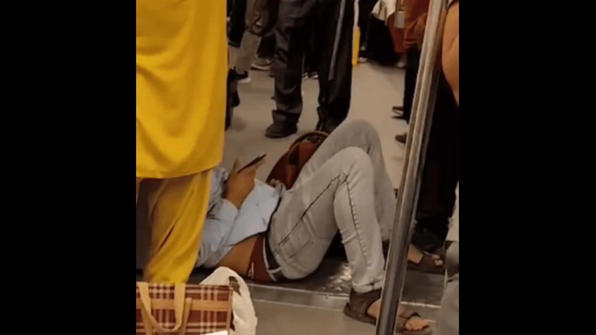 viral-video-man-casually-chilling-on-delhi-metro-floor-to-use-phone-leaves-internet-disgusted-watch