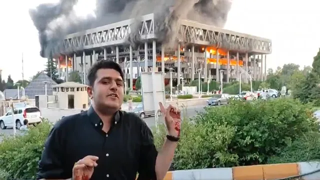 israel-airstrike-with-burning-iran-state-tv-buildingin-background-injured-correspondent-reports-we-are-not-leaving-watch