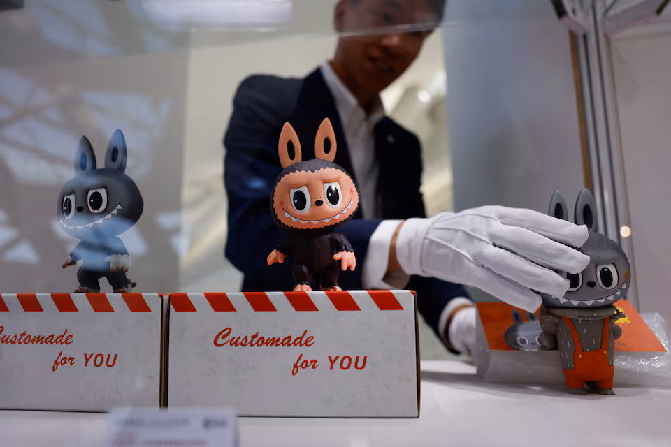 A staff member displays Labubu figurines at a preview exhibition before Yongle International Auction in Beijing