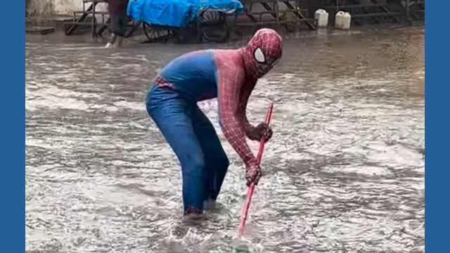 viral-video-mumbai-floods-get-filmy-twist-as-spider-man-turns-cleaner-with-a-mop-in-hand