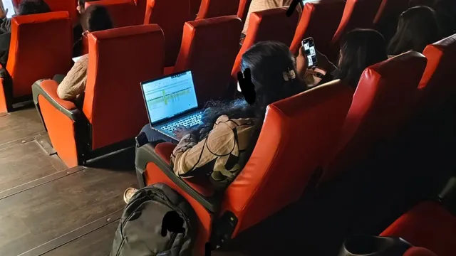 bengaluru-woman-works-on-laptop-inside-theatre-while-watching-lokah-viral-post-fuels-work-culture-debate
