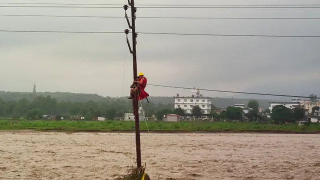 dehradun-flash-floods-ndrf-saves-child-stranded-on-electric-pole-amid-ravaging-waters-watch