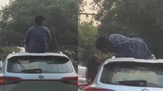 Delhi Man Climbs Over Moving Car's Roof And Kisses Girlfriend; Police Step In To Penalise Reckless Act | VIDEO