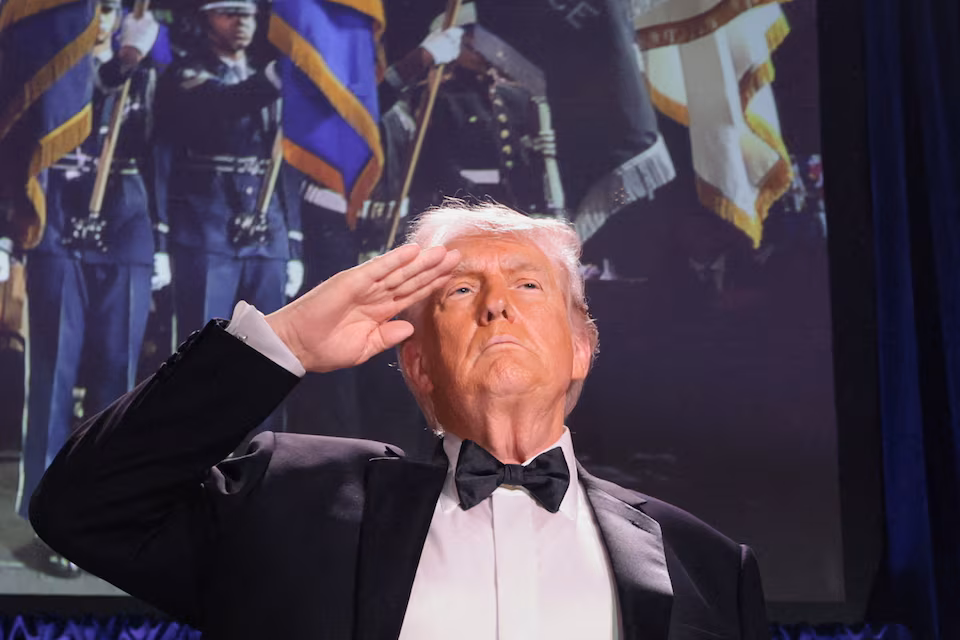 U.S. President Donald Trump salutes during the annual White House Correspondents' Association dinner in Washington