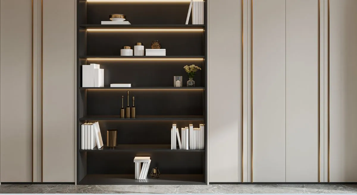Seamless light oak built in floor to ceiling bookcase in a modern small living room