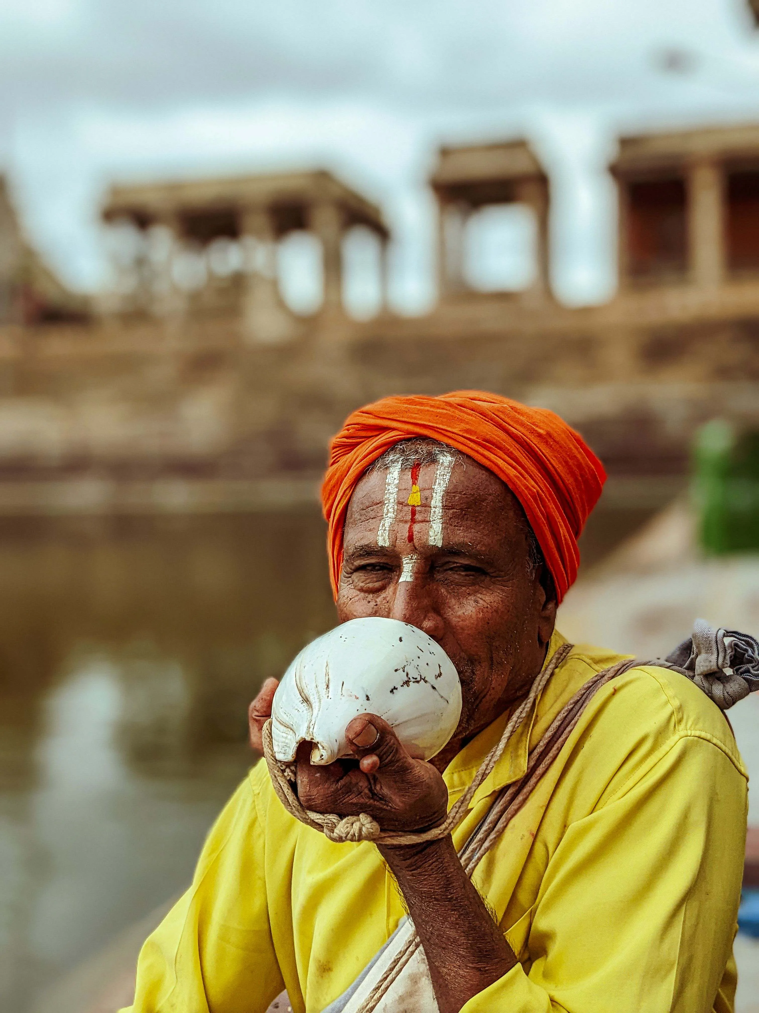 a person blowing shankh