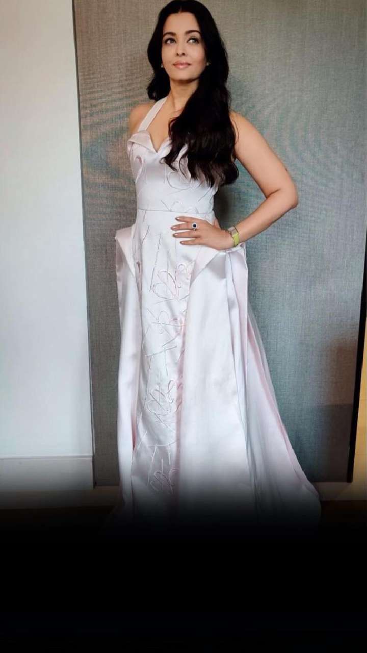 Aishwarya Rai in a navy & white silk Giorgio Armani Prive bustier style  dress with a silver Ferragamo clutch | Style Darling Daily