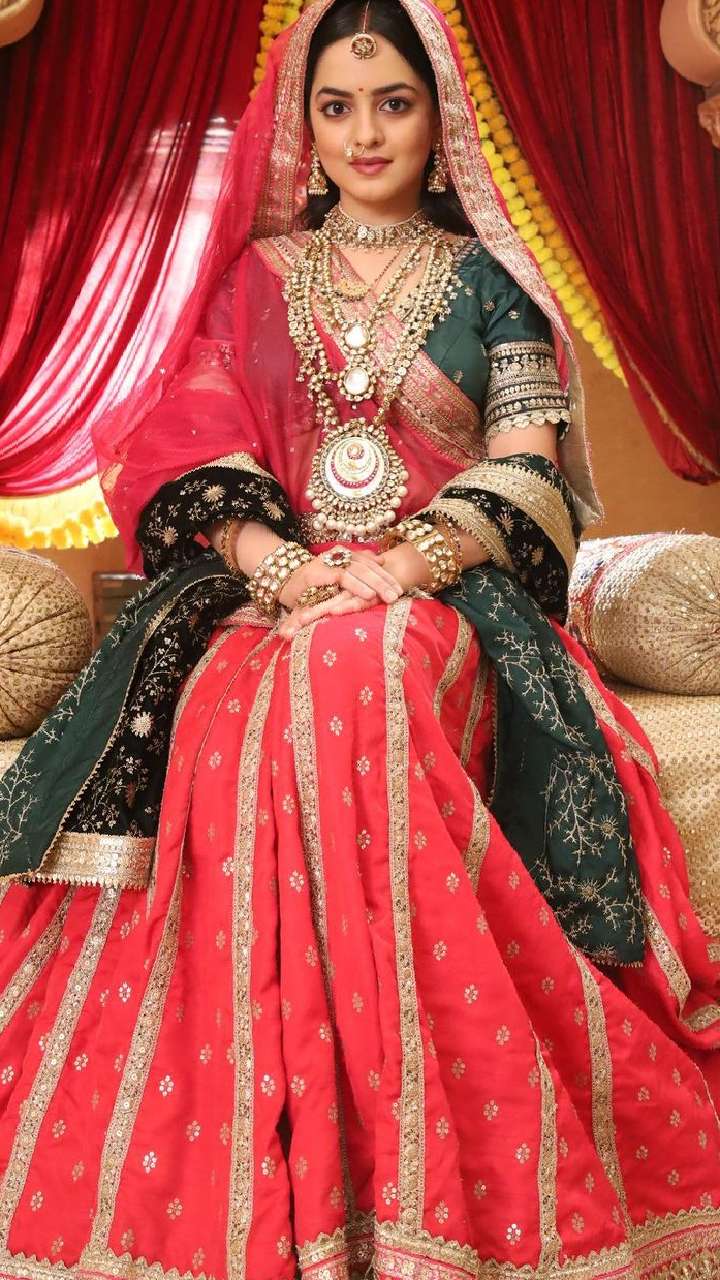 Photo of Bride wearing a red lehenga with contrasting jewellery.